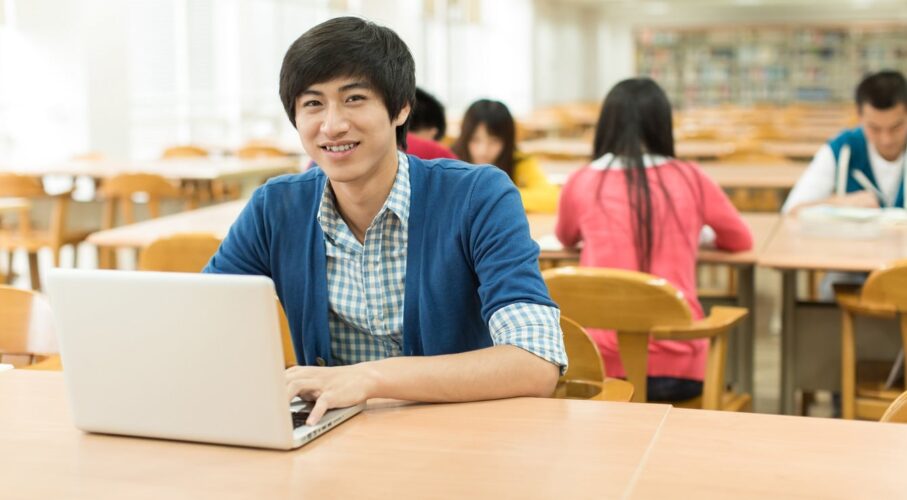 1 College Student On Campus students looking at laptop