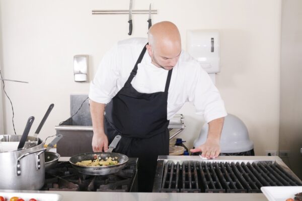 A professional chef cleaning the kitchen.