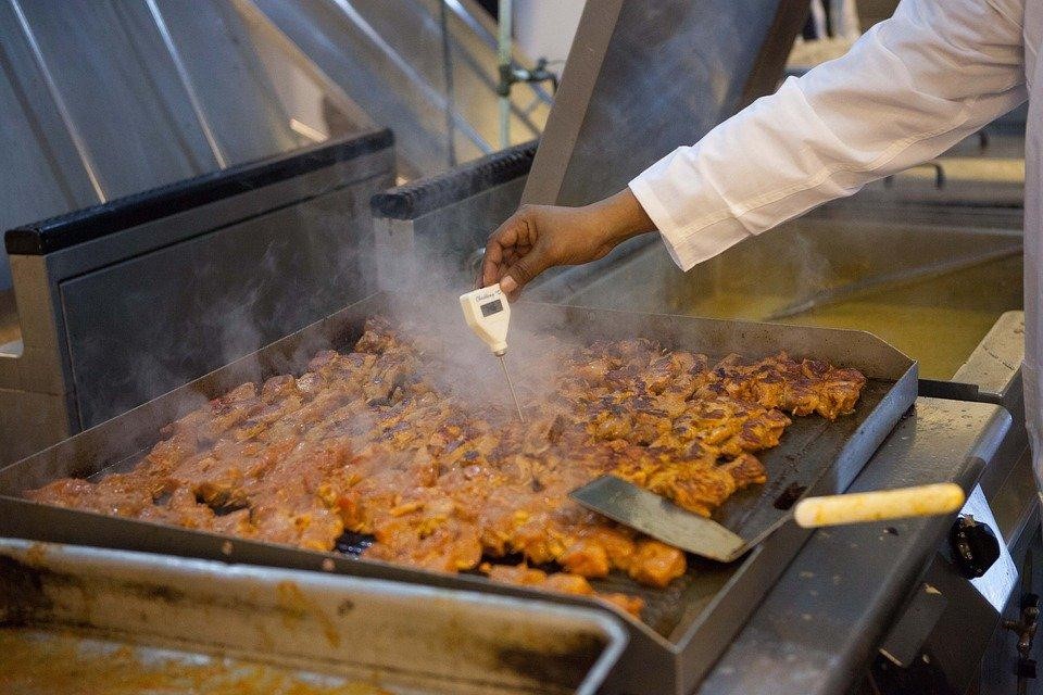 A restaurant employee cooking food