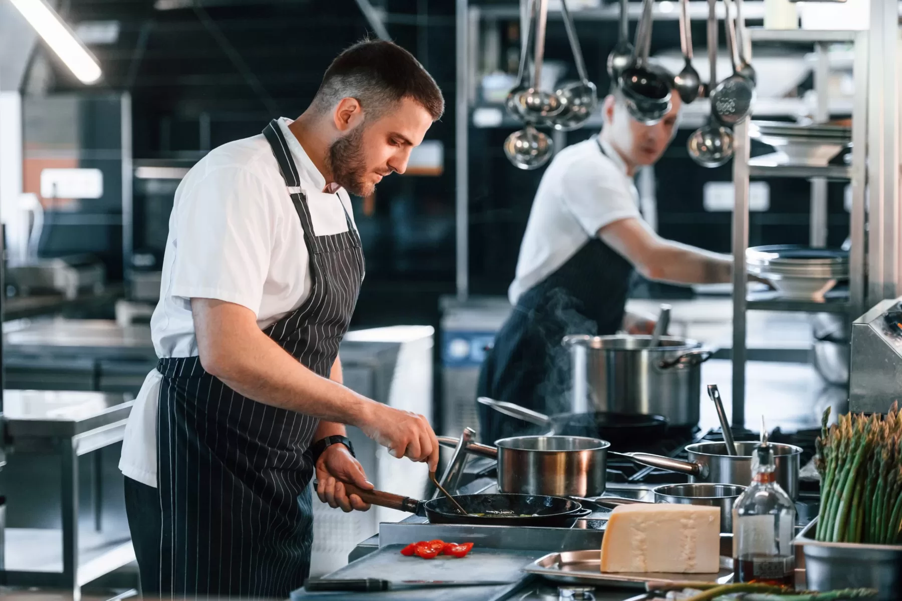 two chefs working in kitchen